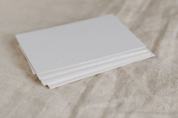 stack of white cards on ivory cloth