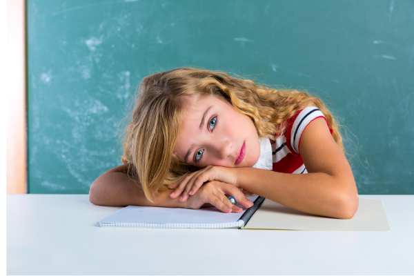 Girl with head laying on desk