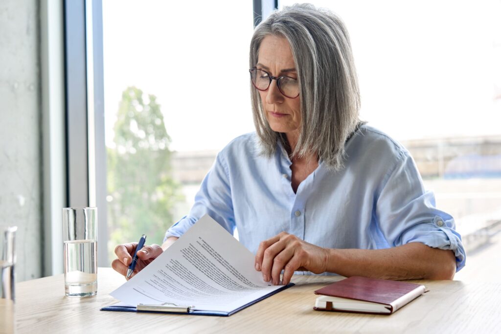 older-woman-signing-documents older-woman-signing-documents