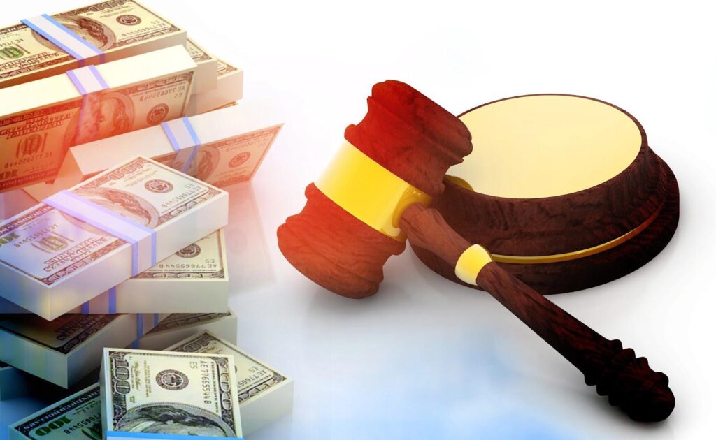 A gavel and soundblock sits beside several wrapped stacks of cash. Both alimony and child support are payments based partially on income that could be ordered in a divorce.
