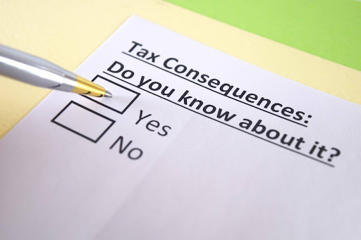 A white paper with the words “Tax Consequences: Do you know about it?” above checkboxes for yes and no. A pen hovers over yes. High net worth divorces can have significant tax implications.