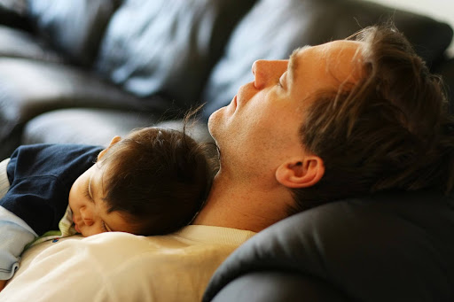 A father napping with an infant asleep on his chest; legal parentage in South Carolina.