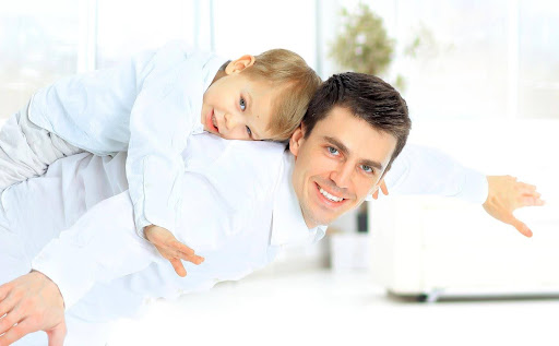 A father and son imitate airplanes. Either parent can seek sole legal custody of their child in North Carolina, even if they share joint physical custody.