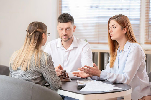 A couple discussing collaborative law divorce and divorce appeals with their attorney.