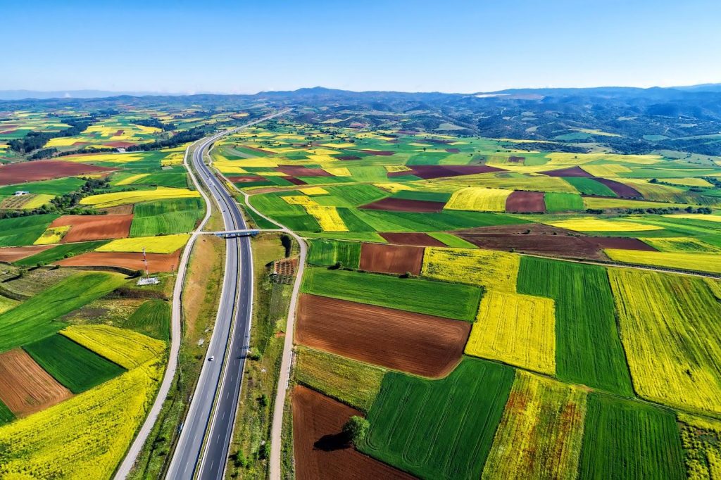 Large tracts of land with a highway running through; long term use may lead to prescriptive easements, which can cause conflicts over property rights.
