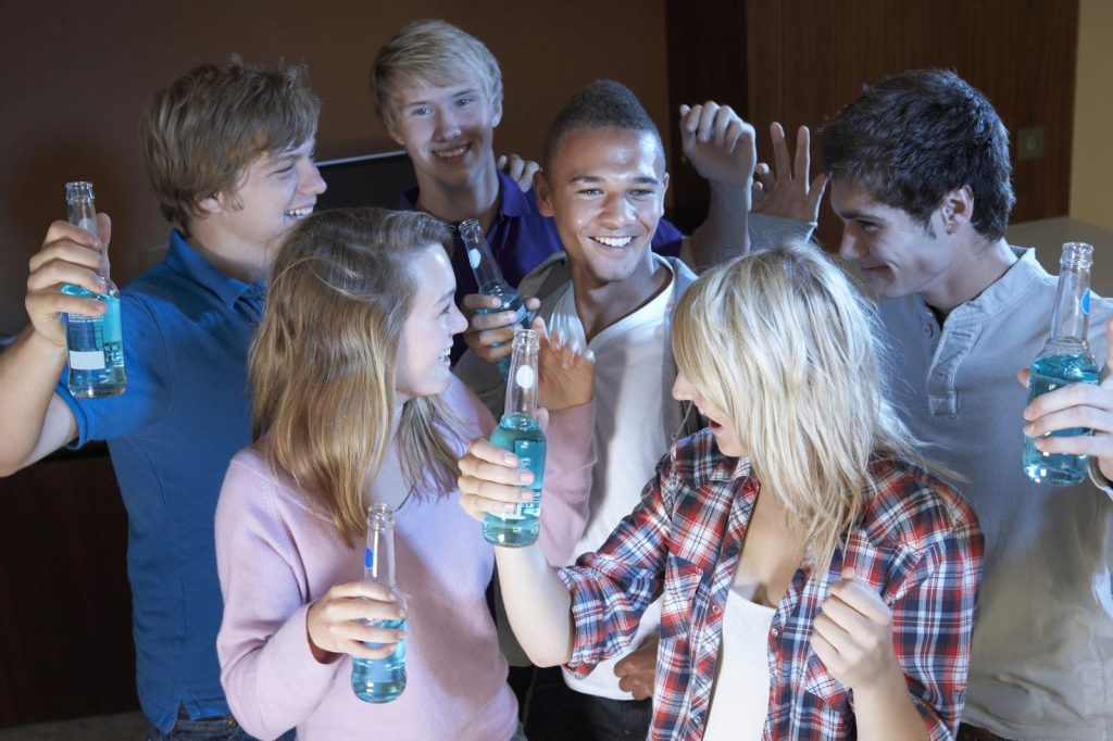 A group of teenagers partying over spring break; criminal violations may raise questions of teen rights and lead to juvenile charges.